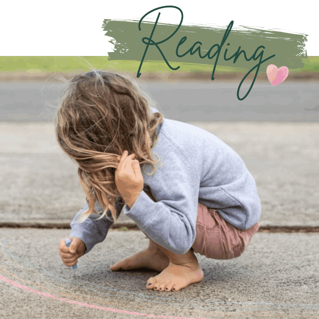 Child with long hair and face turned and painted toe nails drawing on the ground with chalk